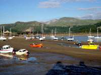 Cadair Idris and Craig-las from Barmouth with the rail and footbridge beyond the boats